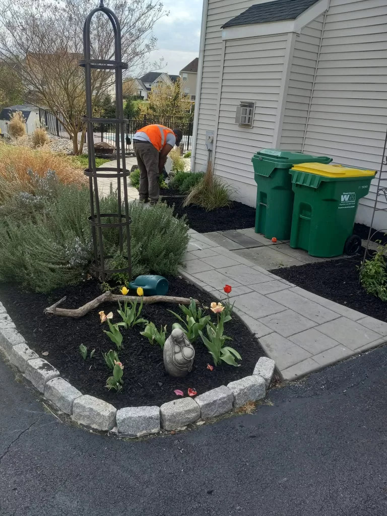Grass Guys team member working on a landscape bed